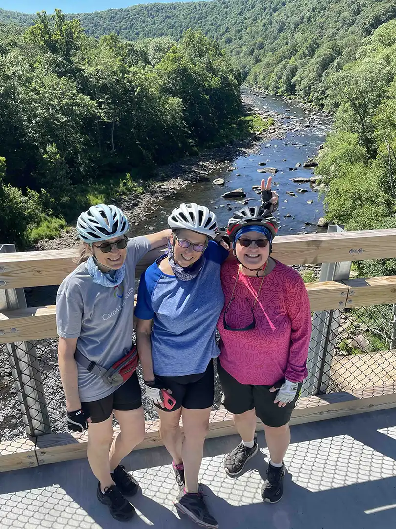 TrailKeepers crossing a trail bridge together