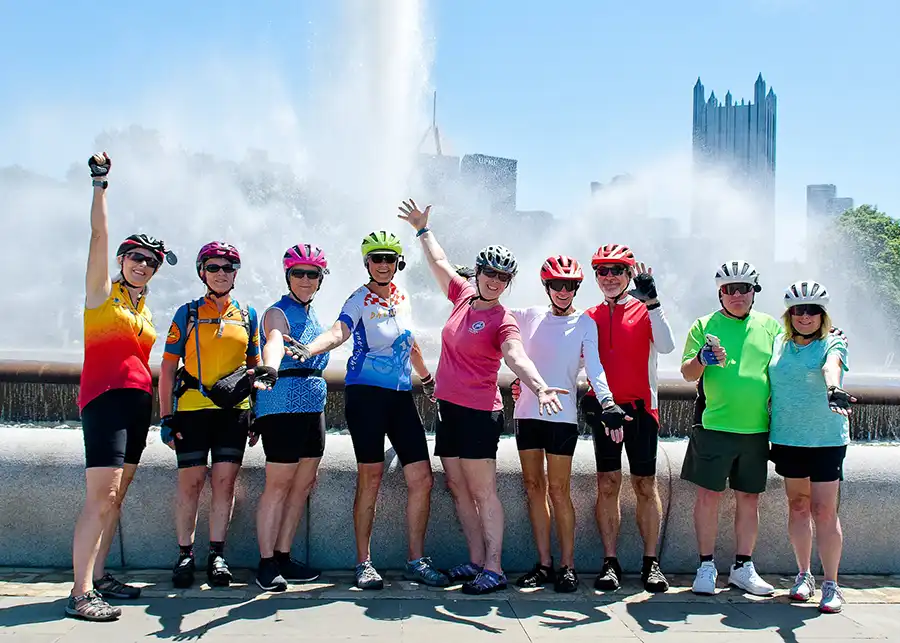 A group of cyclists at the Pittsburgh fountain, the trail's western start
